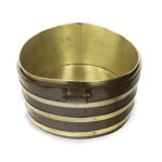 A late Georgian brass bound mahogany oyster bucket, of oval form with three brass bands, wooden volute handles and the original brass liner. English, 1810 Side
