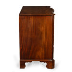 A mahogany four-drawer serpentine chest of drawers, with four graduated drawers, fluted cut corners, orgi braket feet side