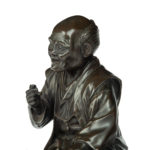 A Meiji period bronze of a seated man smoking details