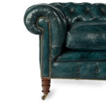 A late Victorian two-seater Chesterfield sofa arm