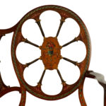 A late Victorian satinwood wheel back settee in the Chippendale style, attributed to Wright and Mansfield details
