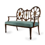 A late Victorian satinwood wheel back settee in the Chippendale style, attributed to Wright and Mansfield detail