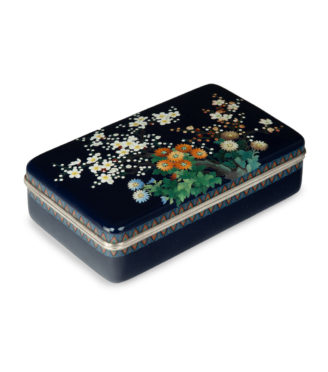 A Meiji period cloisonné box and cover, Ando Company, worked in silver wire and coloured enamels with an array of brightly coloured flowers, reserved against a rich midnight-blue ground, with silver rims and a silk lining, inlaid Ando mark.  Japanese, circa 1910.