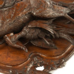 A pair of walnut Black Forest game plaques close up details