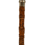 A finely carved fruitwood cane with royal and masonic symbols detail
