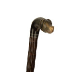 An antique Victorian cane with a smiling dog’s head