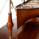 A working model of a ship’s personnel lifeboat on davits detailing