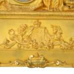 An ormolu mantel clock with Queen Victoria in medieval dress