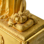 An ormolu mantel clock with Queen Victoria in medieval dress crown detail