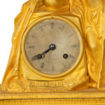 An ormolu mantel clock with Queen Victoria in medieval dress clock