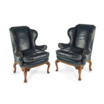 A pair of generous George I style walnut wing arm chairs