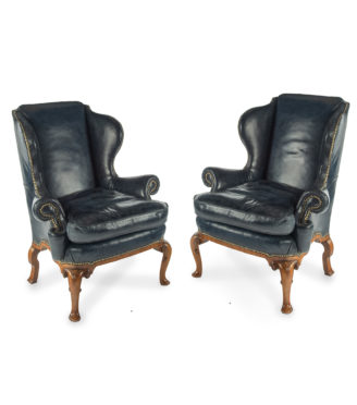 A pair of generous George I style walnut wing arm chairs