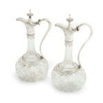 A pair of silver-mounted crystal Royal presentation claret jugs