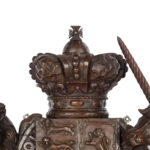 A Victorian carved oak Royal Coat of Arms, the central shield quartered with the three lions England, an Irish harp and a lion rampant surmounted by a crown and supported by the lion and unicorn, with the flowers of the union and motto ‘Dieu et Mon Droit’beneath detail