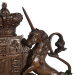 A Victorian carved oak Royal Coat of Arms, the central shield quartered with the three lions England, an Irish harp and a lion rampant surmounted by a crown and supported by the lion and unicorn, with the flowers of the union and motto ‘Dieu et Mon Droit’beneath