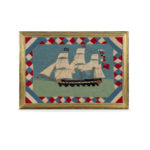 A Victorian wool picture of a three masted frigate flying several flags and ensigns