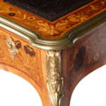 A Victorian kingwood marquetry writing table corner