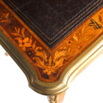 A Victorian kingwood marquetry writing table corner