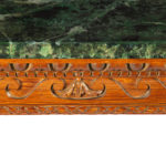 A late Victorian pitch pine console table after Linnell, the rectangular top set upon a frieze carved with Vitruvian scrolls and surmounted by a painted faux marble top, all raised upon six powerful cabriole scroll legs carved with acanthus leaves