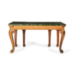 A late Victorian pitch pine console table after Linnell, the rectangular top set upon a frieze carved with Vitruvian scrolls and surmounted by a painted faux marble top, all raised upon six powerful cabriole scroll legs carved with acanthus leaves on the knees above scale pattern panels back