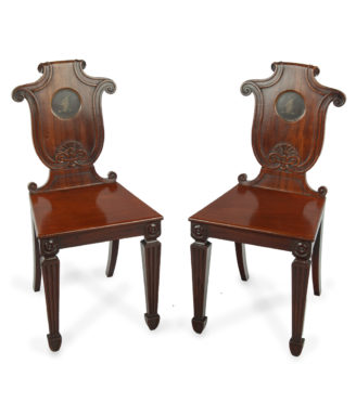 A pair of rare Regency mahogany hall chairs from the Bateson family of Belvoir Park, attributed to Seddon and Sons