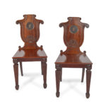 A pair of rare Regency mahogany hall chairs from the Bateson family of Belvoir Park, attributed to Seddon and Sons