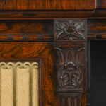 A Fine George IV Period Rosewood Chiffonier or Side Cabinet with Carved Detailing and Ormolu Gallery, of breakfront form, this fine piece is veneered throughout in the highest quality rosewood. It combines fine carved details such as the moulding on the frieze, the floral paterae, reeded ogee feet and the stop fluted columns with the use of gilt brass or ormolu. The doors retain their original gilt brass door panels, of restrained Gothic inspiration, and the pierced gallery to the top which utilises a repeating floral scroll motif details